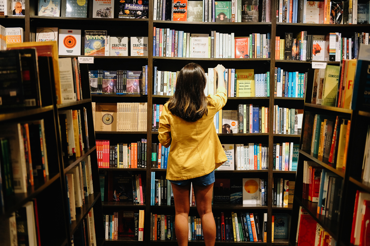 Woman Looking for Books in the Store